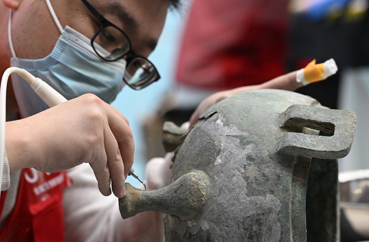 A contestant takes part in a match of metal cultural relics restorer during the national cultural relics industry vocational skills competition in Taiyuan, north China's Shanxi Province, March 25, 2023. (Xinhua/Li He) A contestant takes part in a match of metal cultural relics restorer during the national cultural relics industry vocational skills competition in Taiyuan, north China's Shanxi Province, March 25, 2023. (Xinhua/Li He)