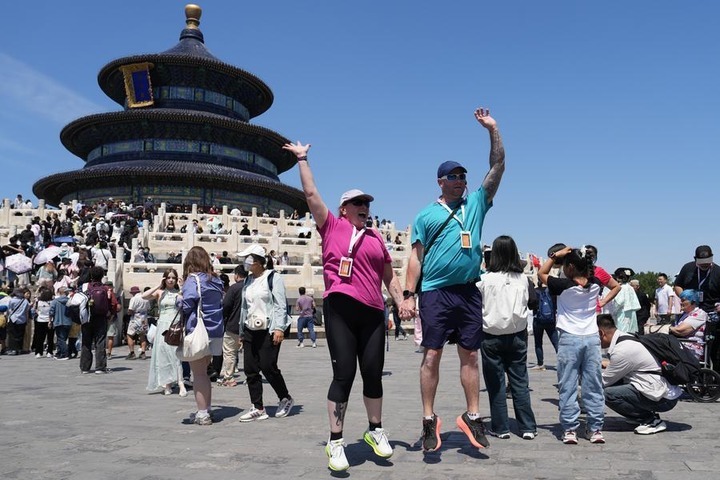 Tourists from Australia pose for photos at the Temple of Heaven Park in Beijing, capital of China, May 1, 2025. (Xinhua/Ju Huanzong)