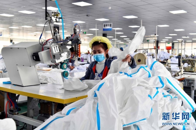 在山东省巨野县一家针织企业,工人们生产出口的防护服(2020年12月24日摄)。 在山东省巨野县一家针织企业,工人们生产出口的防护服(2020年12月24日摄)。