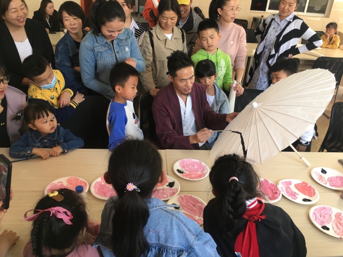 孩子们学习在油纸伞上作画